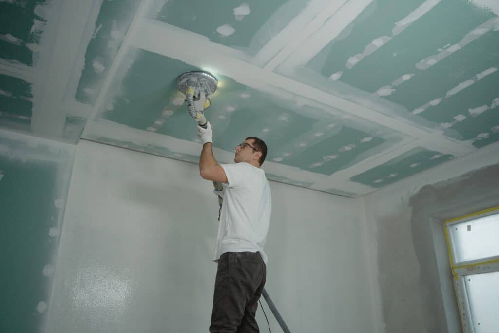 man working on light fixture in home under construction single close construction loan
