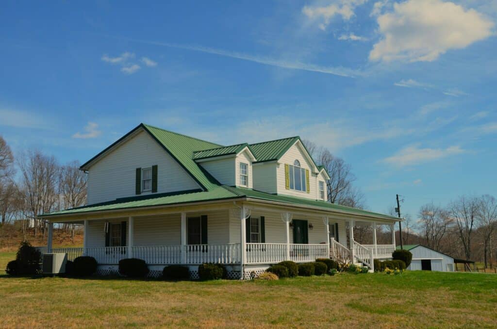 a large white house with a green roof